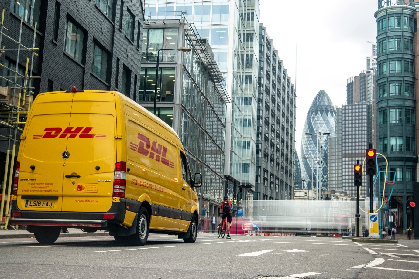 A DHL van driving in a city