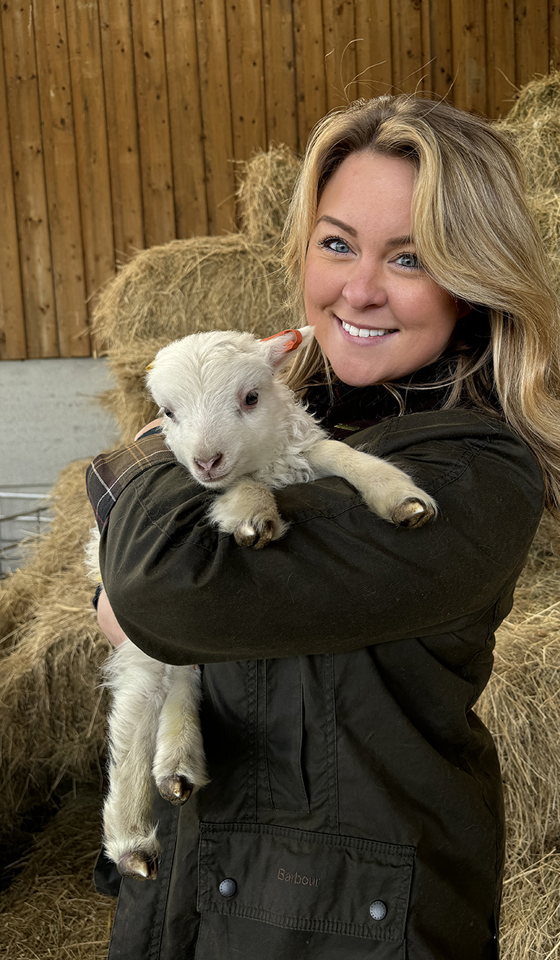 Prologis employee holding a lamb at Lilbourne Meadows, Prologis RFI DIRFT