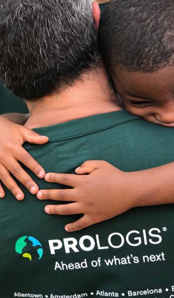 Child hugs a Prologis Employee on IMPACT Day