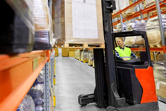 Man in red forklift in a warehouse