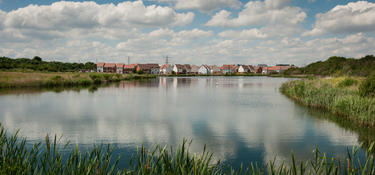 View of The Bridge development across a body of water