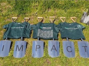 Five shovels that spell Impact on the ground with Imact Day tshirts