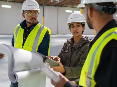 Three Prologis employees working in a warehouse