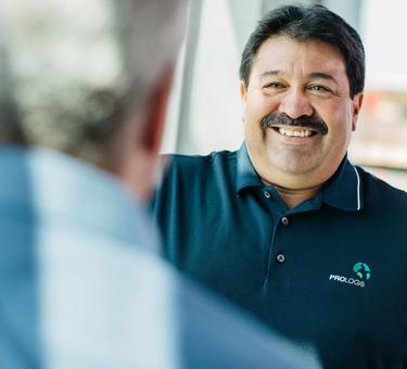 Maintenance technician David Huajardo smiling at a coworker